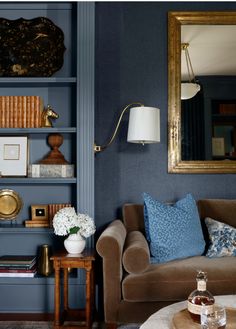 a living room filled with furniture and a large mirror