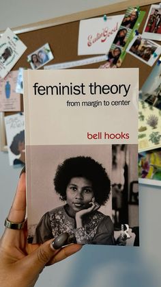 a person holding up a book about feminist theory