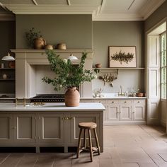 a large kitchen with an island and stools