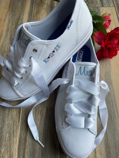 What a comfy way to walk down the aisle. These are Keds platform sneakers. I will embroider your name on the tongue and a date on the side. I will add ribbon laces, either satin or sheer, (some colors available beside white, message me) You choose the thread color for the words and the hearts. Please write in a color in your order along with personalization. If you are trying to match something please message me and send a photo. Sizes are listed as Woman's sizes A cushiony platform sneaker with White Low-top Bridal Sneakers, Low-top Lace Wedding Shoes For Bride, Customizable Lace-up Wedding Shoes For Bride, White Sneakers With Laces For Bridal Shower, Low-top Wedding Shoes With White Laces For Bridal Shower, Customizable Low-top Sneakers For Anniversary, Wedding Keds, Keds Platform Sneakers, Sneaker Wedding