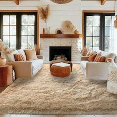 a living room filled with furniture and a fire place in the middle of a room