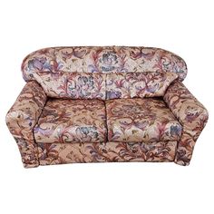 a couch with floral fabric on the back and armrests is shown in front of a white background