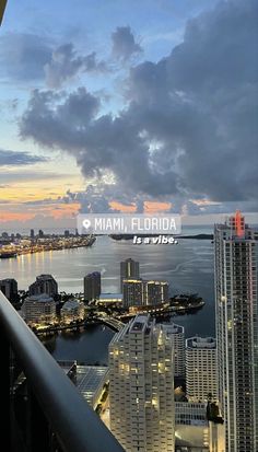 the city skyline is lit up at night with clouds in the sky and buildings on the other side