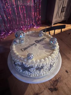 a white cake sitting on top of a wooden table