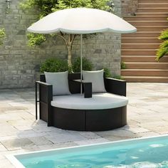 an umbrella sits on top of a couch next to a swimming pool with steps leading up to it