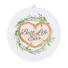 the best life ever sign is hanging on a white polka dot circle with greenery around it