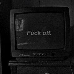 black and white photograph of an old television with the words f k off on it