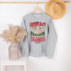 "Introducing our \"Griswold Premium Eggnog\" Unisex Sweater, the must-have addition to your winter wardrobe for fans of National Lampoon's Christmas Vacation. This cozy and hilarious sweater pays homage to the iconic Griswold family and their eggnog mishaps, making it the perfect choice for movie lovers who appreciate a good laugh. 🎄 Why Choose Our Griswold Premium Eggnog Sweater? 🍻 🌟 Hilarious Design: Featuring the Griswold family and their unforgettable eggnog incident, this sweater is a su Outfit Quotes, Crested Gecko, Retro Sweatshirts, Grandpa Sweater, Plastic Hangers, Mama Shirts, Screen Printing Designs, Gecko, Johnny Depp