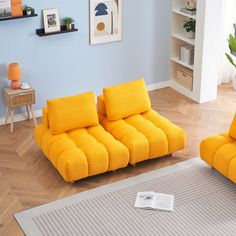 a living room with two yellow couches in it