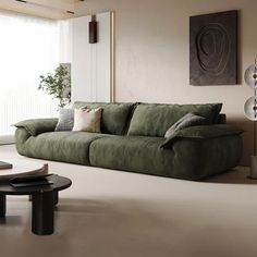 a living room with a green couch and coffee table in front of a large window