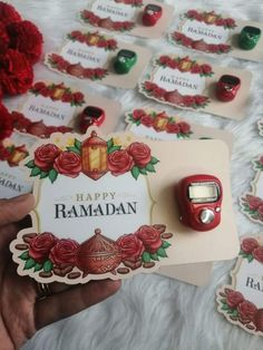 someone is holding up a card with the words happy ramaan on it and some red flowers