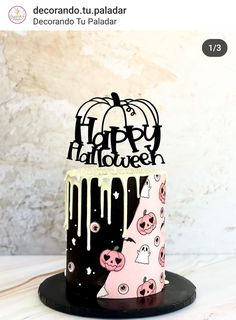 a decorated halloween cake sitting on top of a table