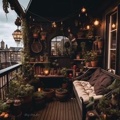 a balcony with lots of potted plants and lights