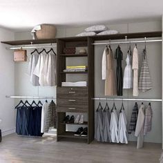 an open closet with clothes hanging on the shelves and shoes sitting on top of them