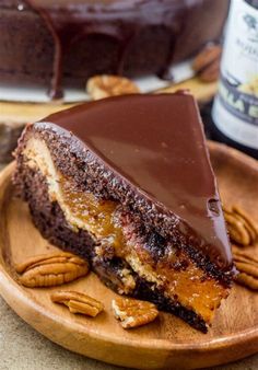 a piece of chocolate cake on a plate with pecans