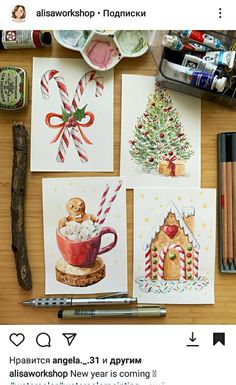 some christmas cards are on a table with markers and paintbrushes next to them