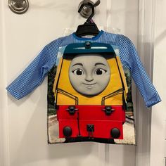 a thomas the train shirt hanging on a door