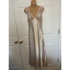 Vintage Victoria's Secret Gold Label Night Gown Slip Dress With Lace Detail Size L Stunning! Champagne Colored Long Nightgown Or Slip Dress. Deep V In The Front And Back. The Bust Is Lace With Strategically Placed Applique. Material-Polyester. Flat Lay Measurements-Length-52 Inches, Pit To Pit-16 Inches, Waist-19 Inches Great Condition. Feminine Bias Cut Nightgown For Wedding Night, V-neck Bias Cut Nightgown For Sleep, Feminine Sleeveless Evening Nightgown, Victoria's Secret Sleeveless Slip Dress For Sleep, Sleeveless Bias Cut Sleepwear, Victoria's Secret Sheer Nightgown For Loungewear, Elegant Victoria's Secret Dress For Wedding Night, Victoria's Secret Daywear Dress With Lace Trim, Victoria's Secret V-neck Nightgown For Loungewear