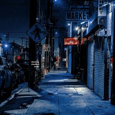 an alley way with cars parked on both sides