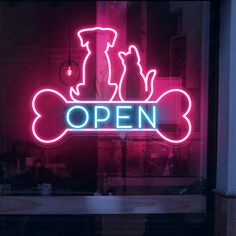 a neon sign that says open with a dog bone