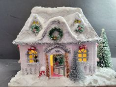 a small pink house decorated with christmas decorations