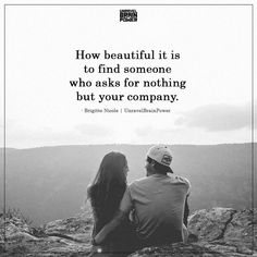 a man and woman sitting on top of a mountain looking at each other with the caption how beautiful it is to find someone who asks for nothing but your company