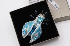 Buy an exclusive gift for your loved one - Beaded brooch Blue Insect! Perfect as Unique statement gift for anniversary, teacher's appreciation gift, Nature lover gift, birthday gift, Christmas gift. The Blue Bug brooch is handmade. The wings are movable. They can be positioned in different positions at your discretion. The Embroidered insect will be well combined with an evening dress, a woman jacket -lapel pin, Jean demin jacket, business suit, warm sweater or scarf as shawl brooch, making a fi Handmade Blue Brooches For Gift, Scarf As Shawl, Shawl Brooch, Brooch Making, Bug Brooch, Demin Jacket, Gift For Anniversary, Wedding Brooch, Warm Sweater