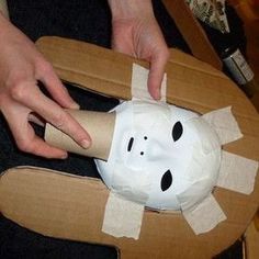 someone is making a paper mache mask out of cardboard