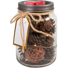 a mason jar filled with pine cones and twine