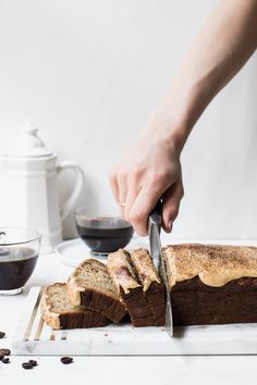 a person is cutting bread with a knife