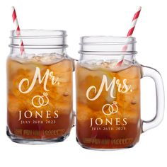 two mason jars filled with iced drinks and straws