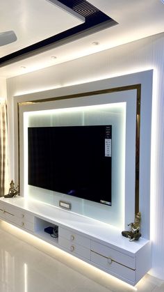 a large flat screen tv mounted to the side of a wall in a living room