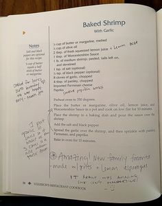 an open book with handwritten instructions on baked shrimp and other food items in it