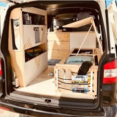 the back end of a van with an open bed and storage area in the trunk