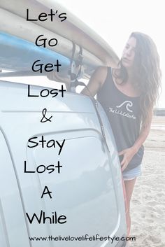 a woman standing next to a van with surfboards on the roof and text overlay that reads let's go get lost & stay at while