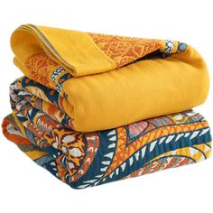 three blankets stacked on top of each other in different colors and patterns, with one folded up