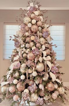 a decorated christmas tree with pink and white ornaments