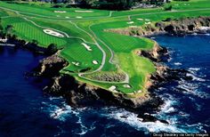 an aerial view of a golf course near the ocean with water and cliffs in the background