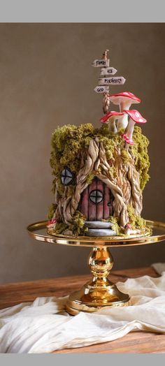 there is a cake that looks like it has been made to look like a mushroom house