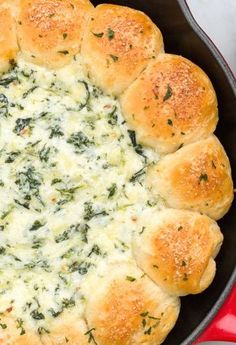 a pan filled with bread and cheese on top of a table