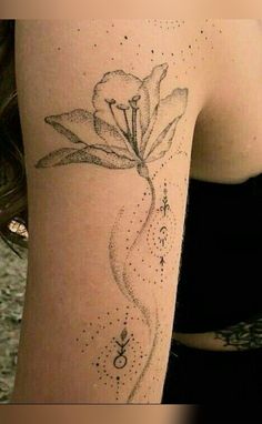 a woman's arm with a flower tattoo on the left side of her body