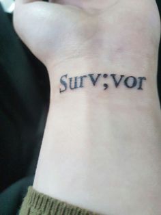 a woman's wrist tattoo with the word survivor written on her left hand, in cursive font