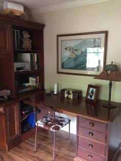 a wooden desk sitting in the middle of a room