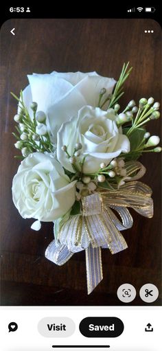 white roses and baby's breath are arranged in a bouquet on the phone screen