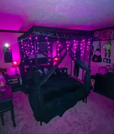 a bedroom decorated in purple and black with pink lights on the ceiling, bed frame