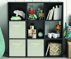 a bookshelf filled with lots of boxes and stuffed animals