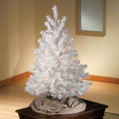 a white christmas tree is sitting on a table