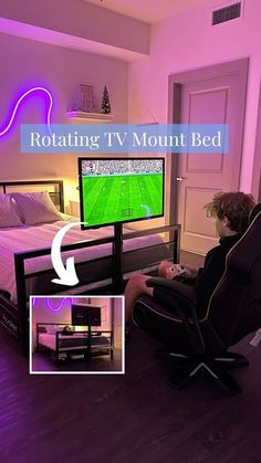 a man sitting in front of a tv on top of a bed