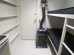 a room with bunk beds and a vacuum on the floor