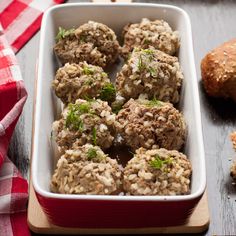 a white dish filled with meatballs on top of a table